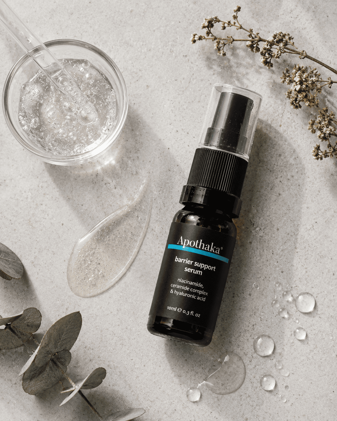 Serum flat-lay concept with hyaluronic gel and botanicals
